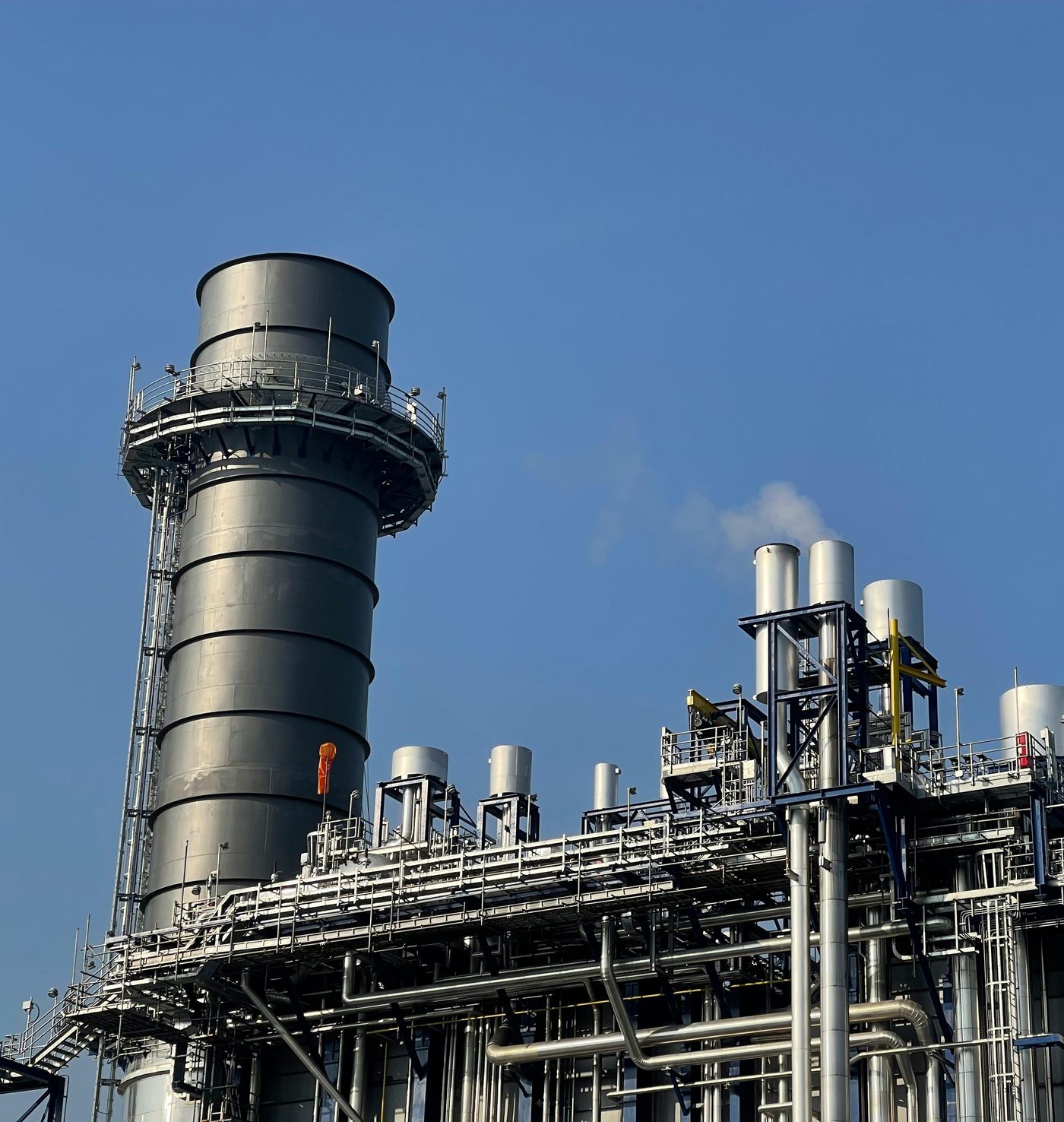 ADV gas-processing plant stack against a clear sky